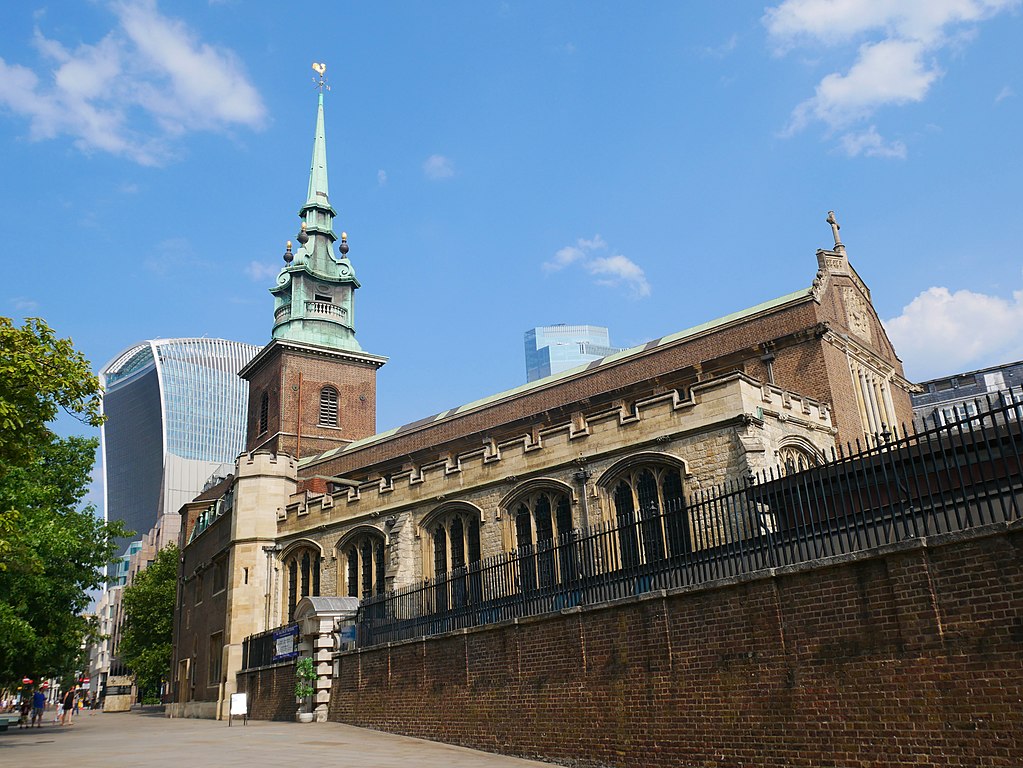 Historic church with a spire alongside modern skyscraper under blue sky. | 2024 | WordPress Theme by MH Themes