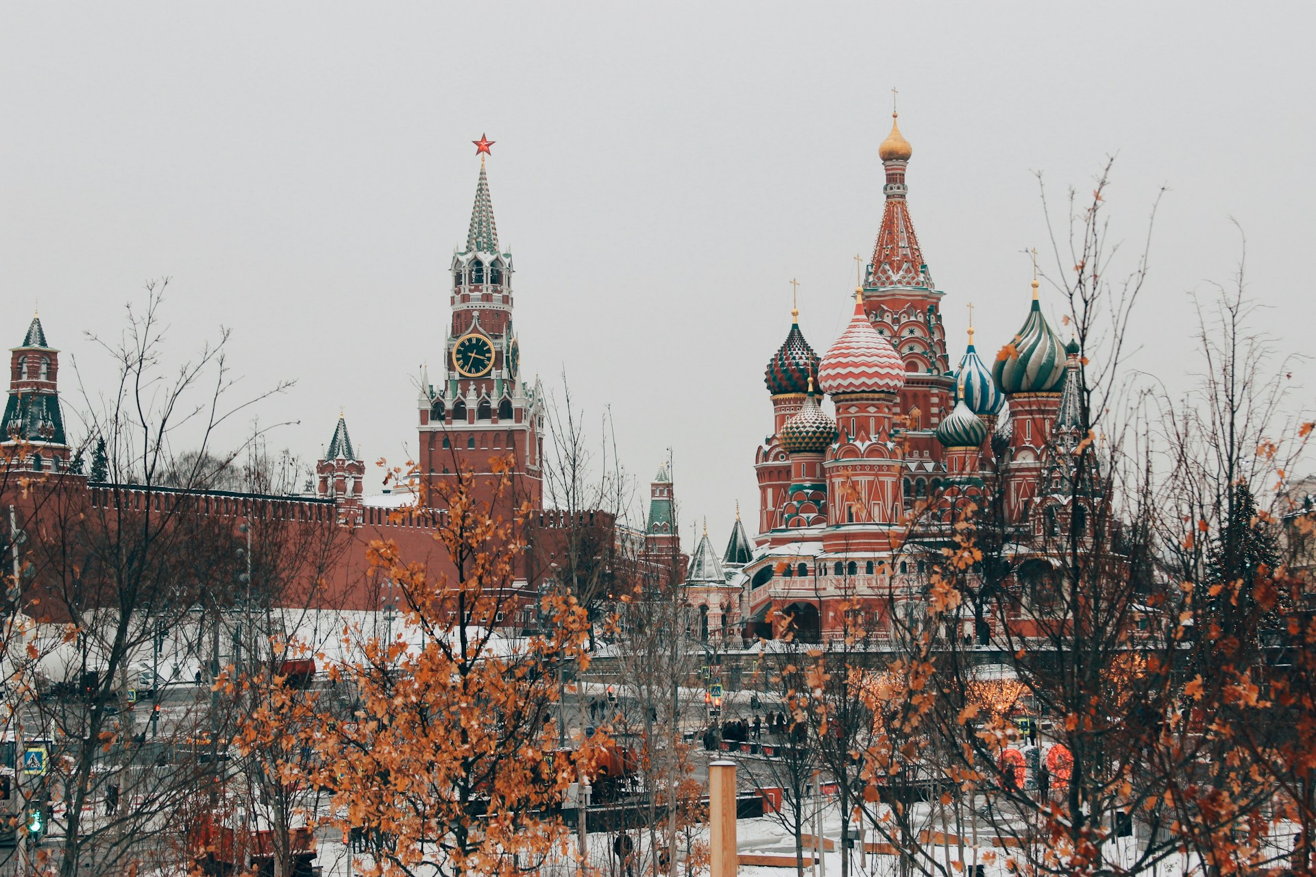 Snow-dusted Kremlin and Saint Basil's Cathedral in Moscow with autumn foliage. | Photo by Michael Parulava on Unsplash