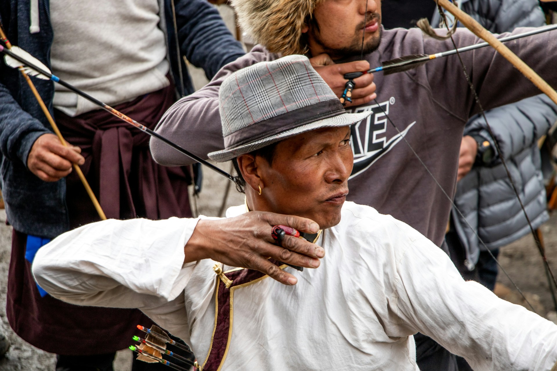 A group of people practicing archery with traditional bows and arrows. | Photo by Sunil Chandra Sharma on Unsplash