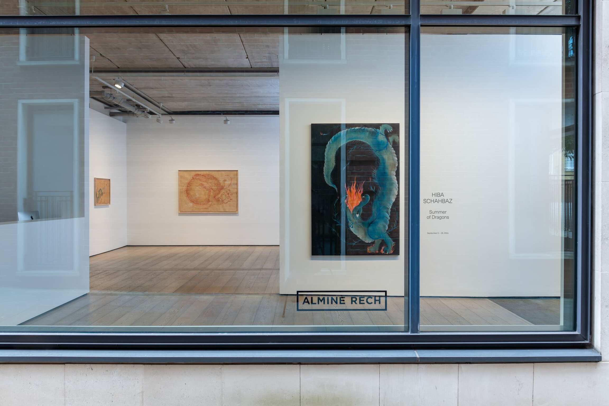 Art gallery interior viewed from outside with text on the window. | 2024 Almine Rech