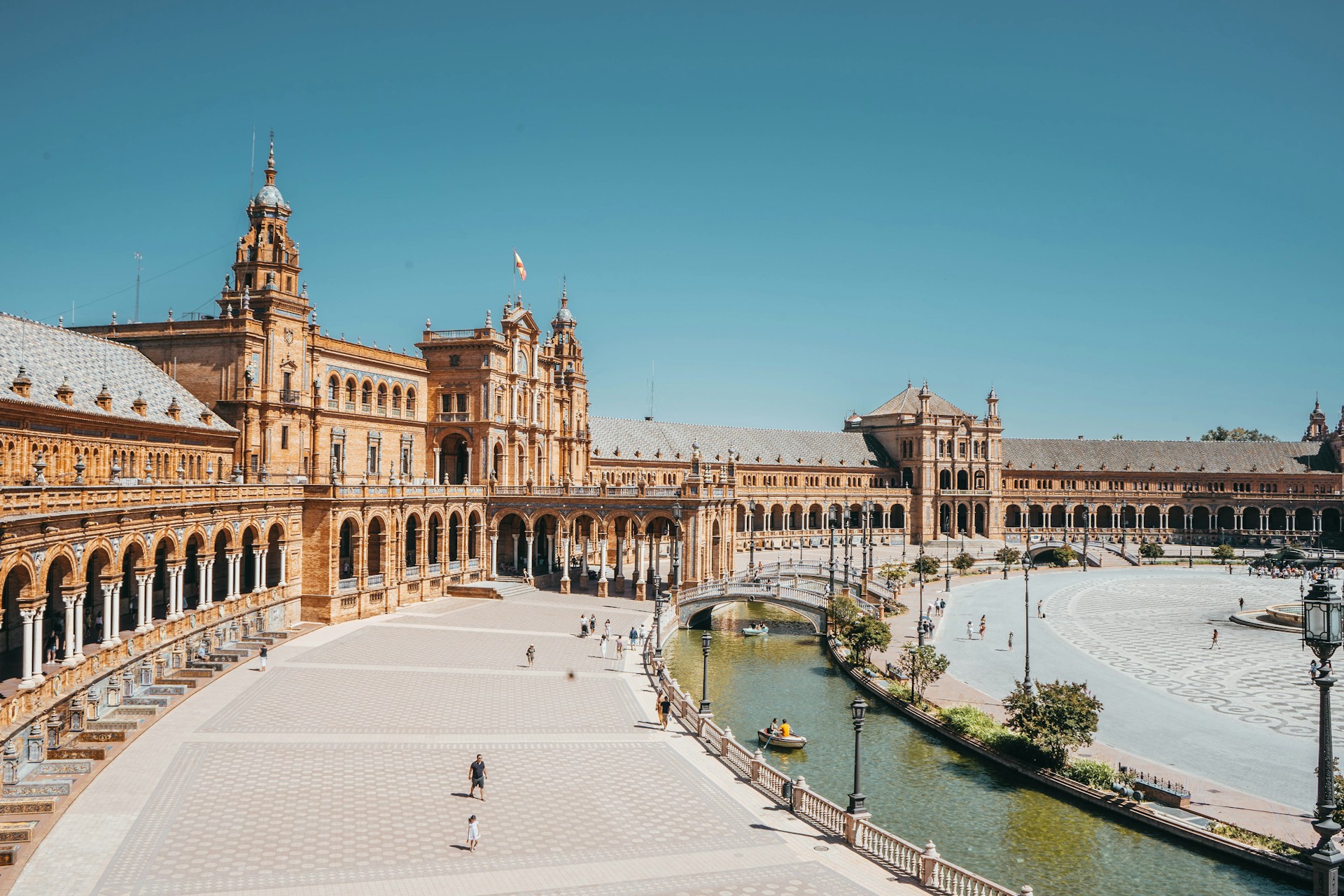 Plaza de España in Seville with its Renaissance/Neo-Moorish architecture, bridge, and canal. | Photo by Joan Oger on Unsplash