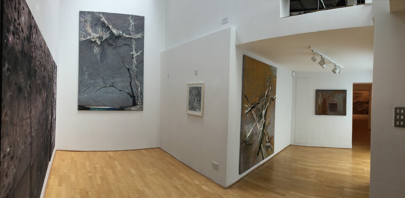 Modern art gallery interior with abstract paintings on white walls and wooden floors. | Art Space Gallery