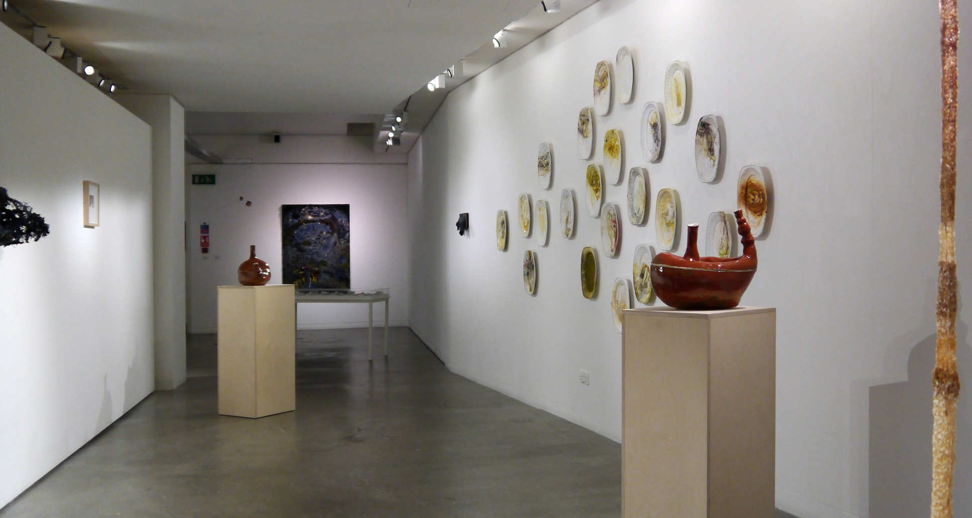 Modern art gallery interior with various artwork displays on walls and pedestals. | 2024 Imperial College London