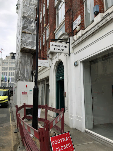 A city street with a "Footway Closed" sign, a building with "Annely Juda Fine Art" signage, and scaffolding. | Annely Juda