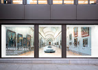 Art gallery window display featuring framed paintings and an interior view of the gallery. | Ben Brown