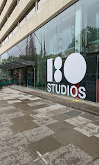 Exterior view of a modern building with large windows and "180 STUDIOS" branding on the facade. | 180 Studios