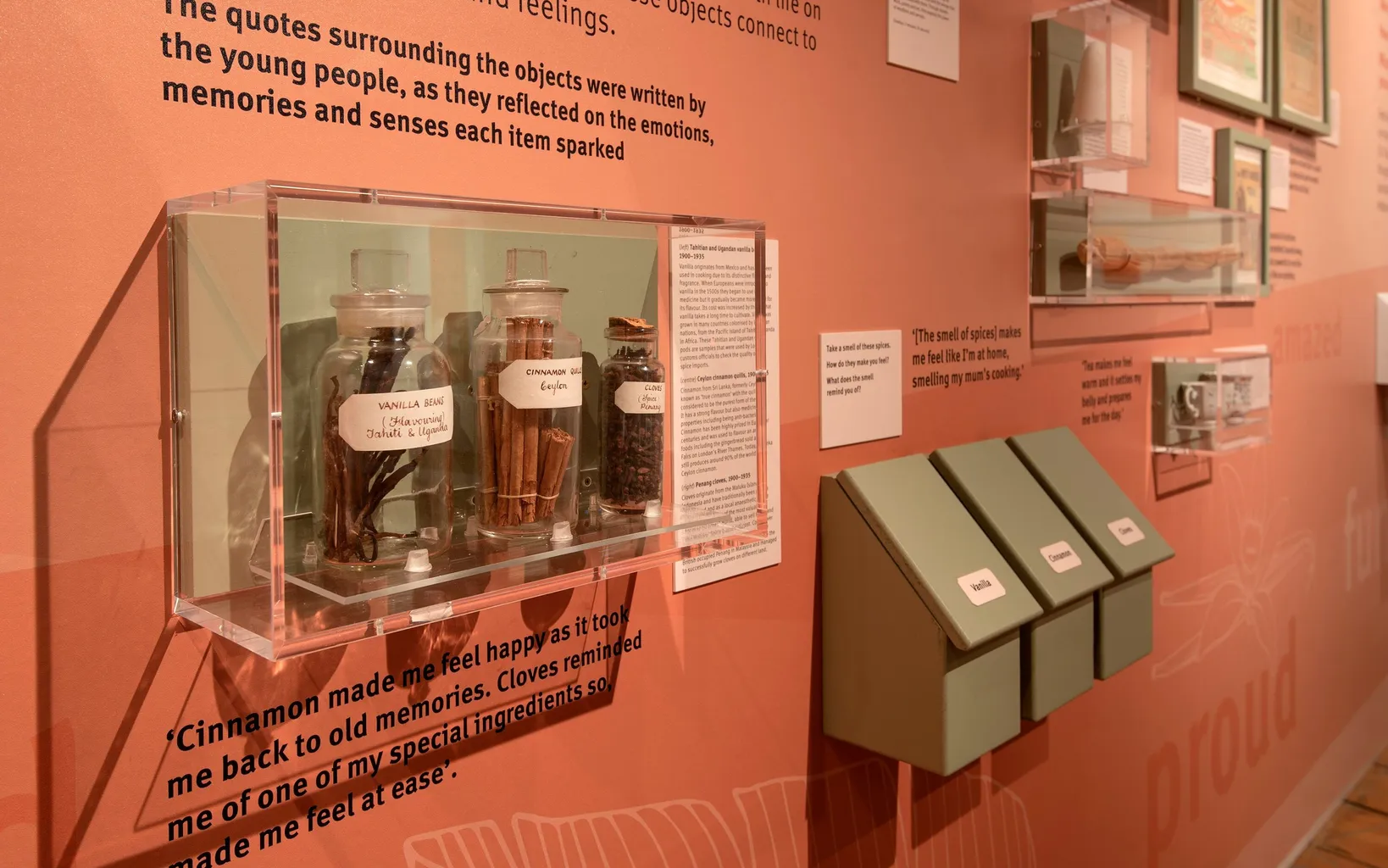 Exhibit with spice jars and quotes about memories they evoke, with interactive scent boxes.