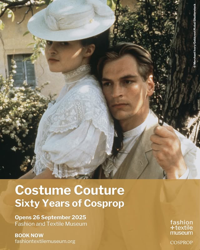 A couple dressed in vintage attire stands outdoors amidst lush greenery, promoting the "Costume Couture" exhibit opening in 2025.