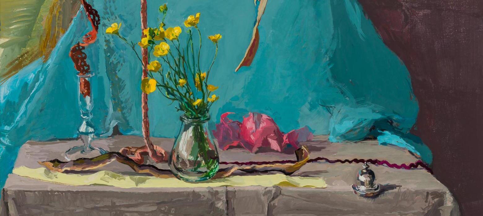 A vibrant still life featuring yellow flowers in a glass vase, surrounded by colorful drapery and decorative elements on a table.