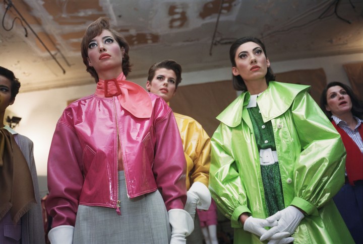 Models wearing vibrant, colorful jackets in a vintage fashion setting, highlighting bold styles and textures.