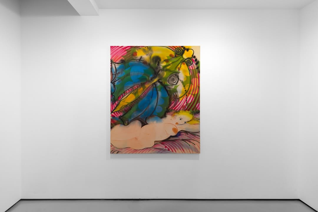 Interior view of a white-walled art gallery exhibiting several paintings, including a figurative piece on the left and an abstract artwork in the center.
