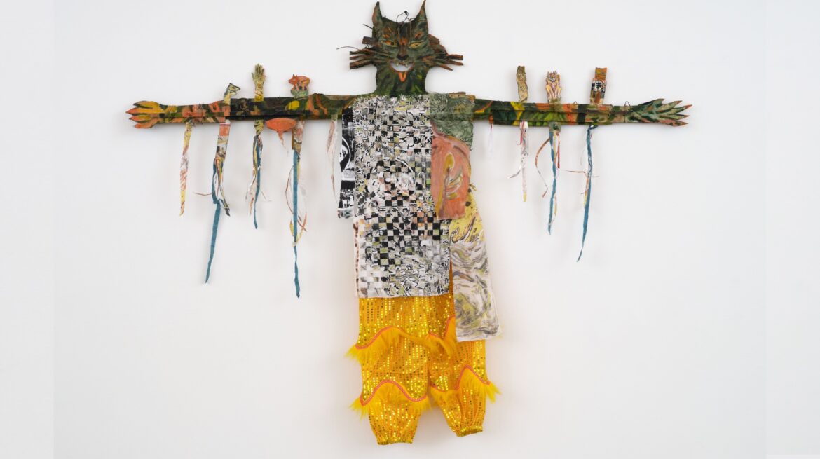 A cat figurine made from fabric, designed as a doll or toy.