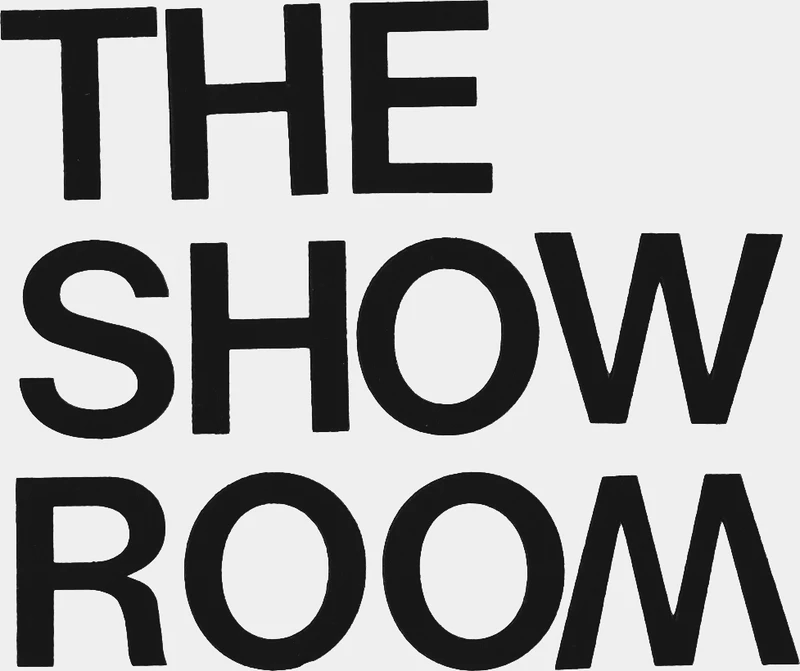Black text that reads "THE SHOW ROOM" on a white background.