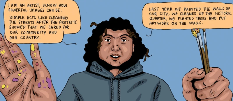 A man with curly hair wearing a hoodie stands confidently, embodying the spirit of community art and activism