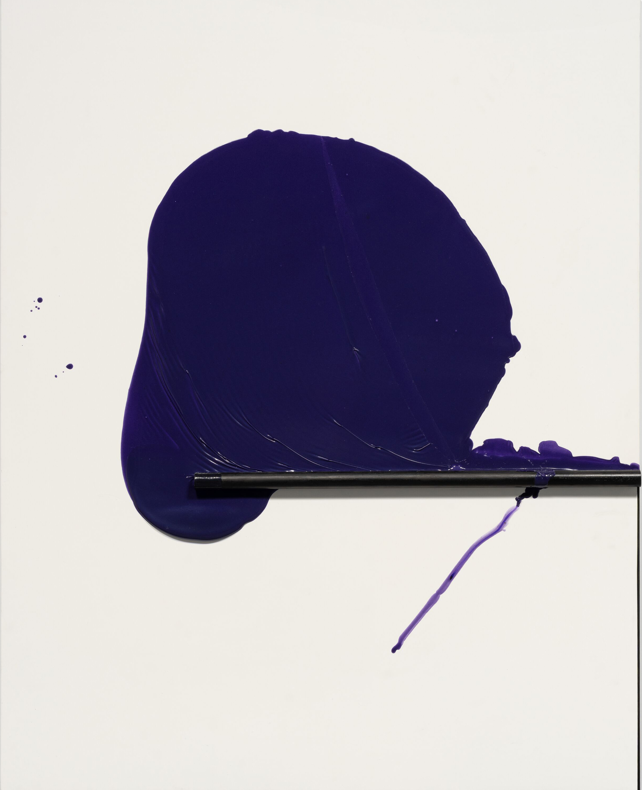 A blue paint splash on a white surface, with a silhouette of a hat in the foreground.