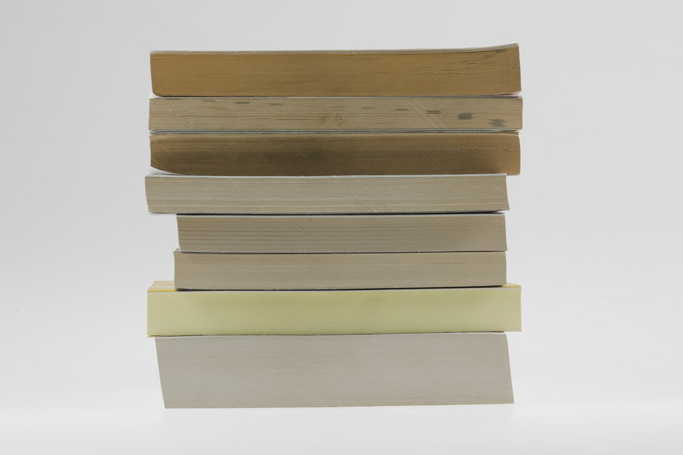 A stack of books placed on a white background.