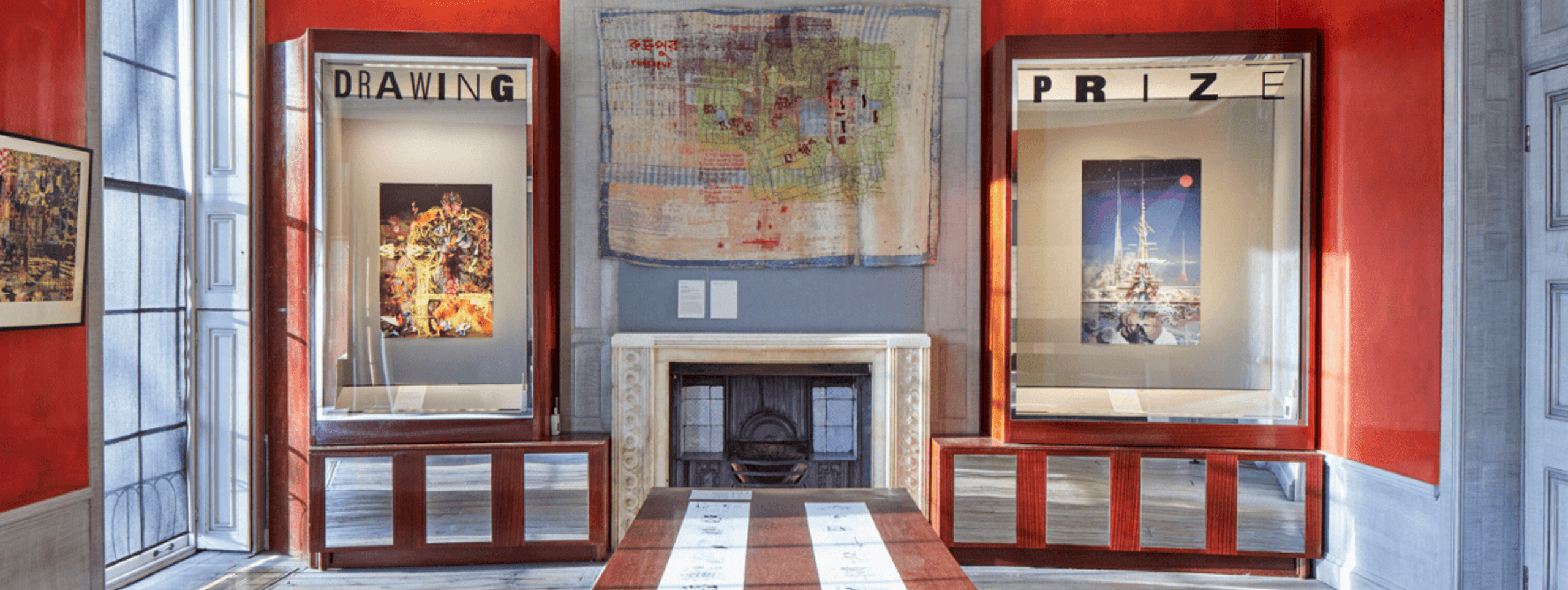 Alt text: A cozy room featuring a fireplace and a dining table, adorned with art on the walls and decorated with various pieces of furniture.