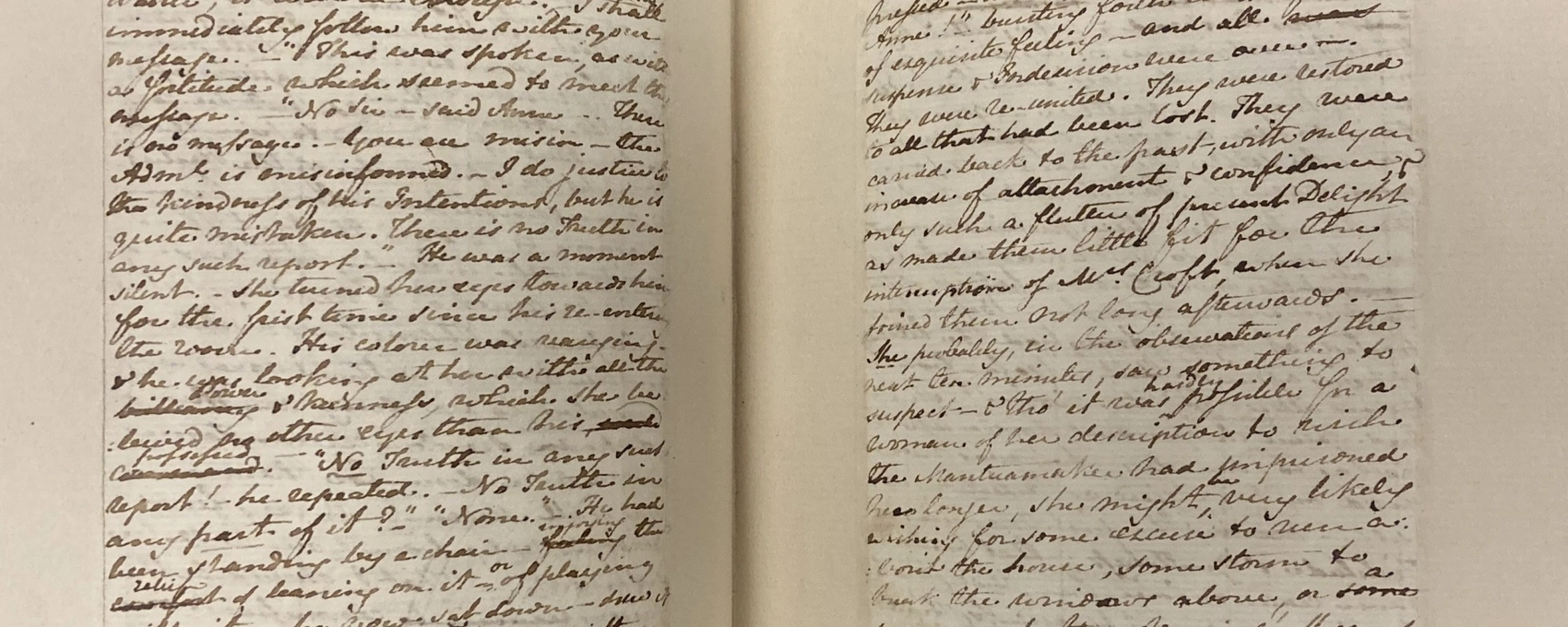 Close-up of a book displaying handwritten text on paper, featuring a visible publication detail.