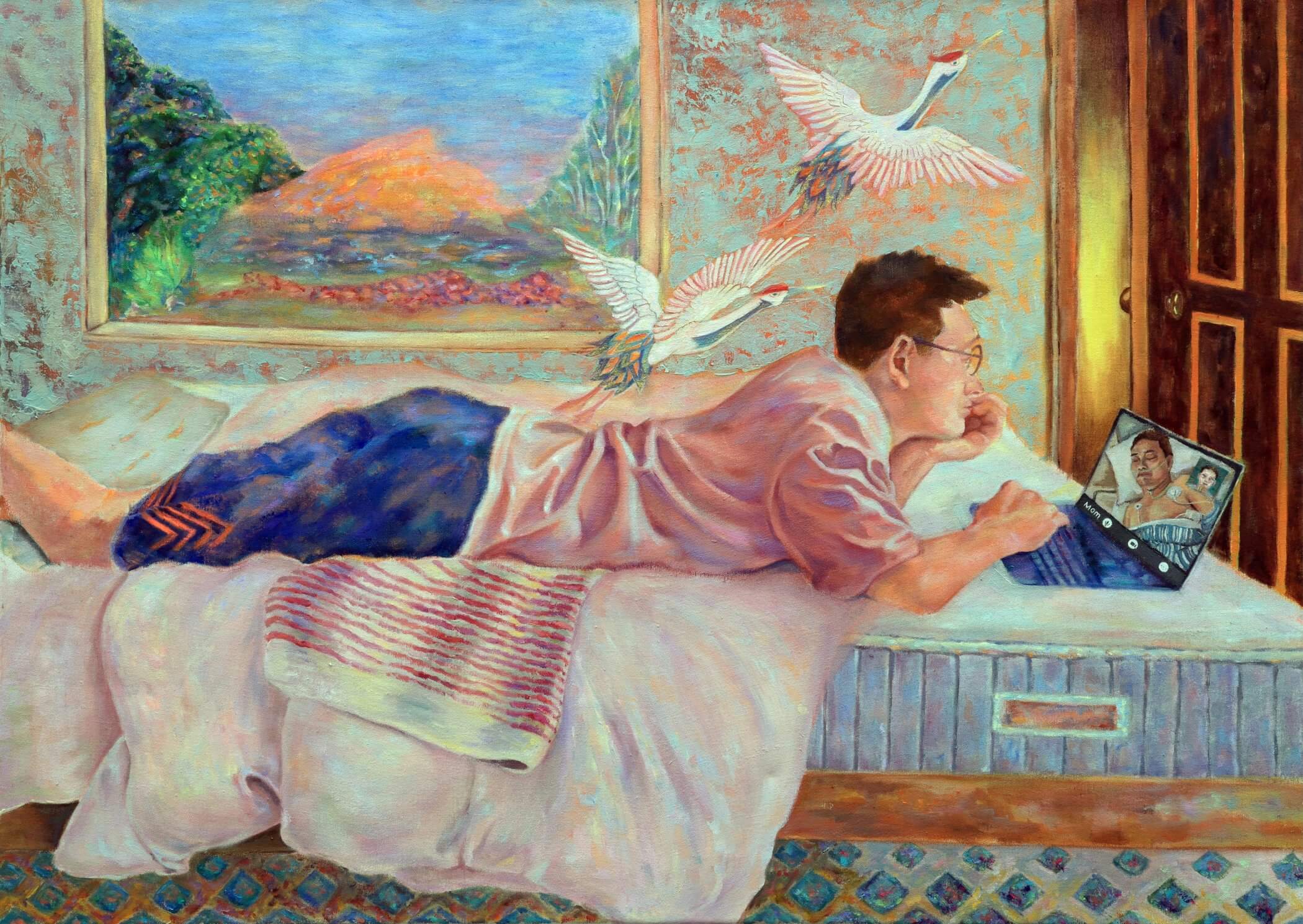 A man lying on a bed, using a laptop. The room has a picture frame and artwork on the walls.