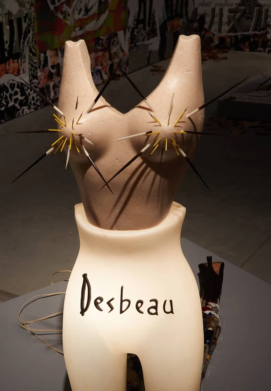 A sculpture of a woman's bust displayed indoors, crafted by Desbeau. The artwork is designed with smooth lines and features a jar-like shape integrated into the sculpture. | 2026 Soft Opening