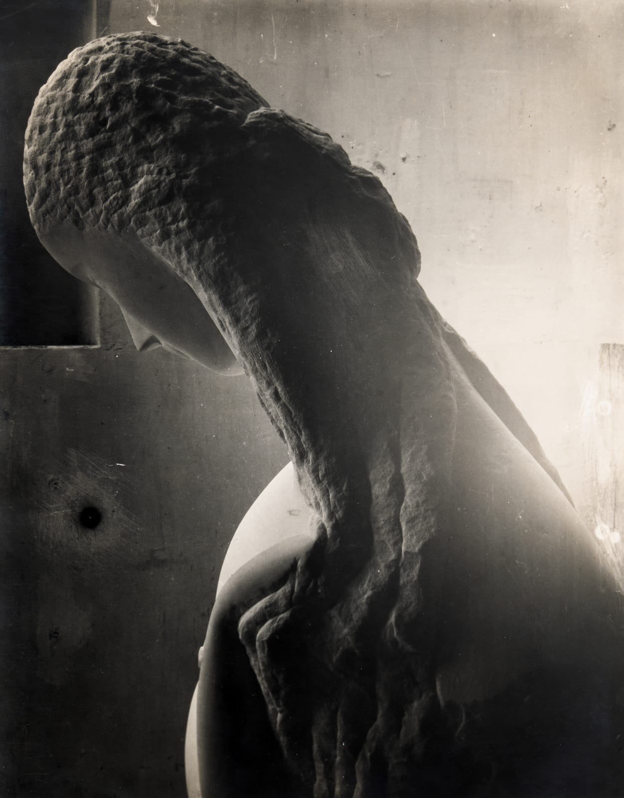 A black and white image of a statue depicting a woman, showcasing intricate details and artistic expression.