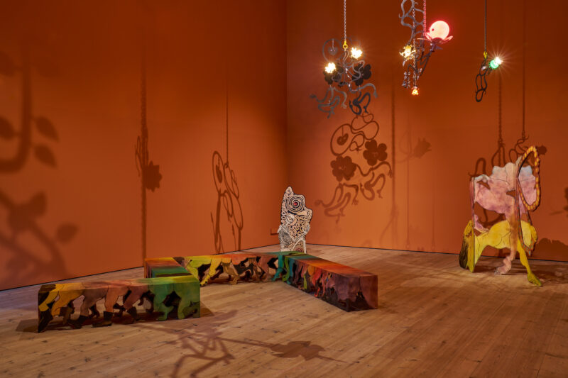A room featuring a wooden floor and orange walls.