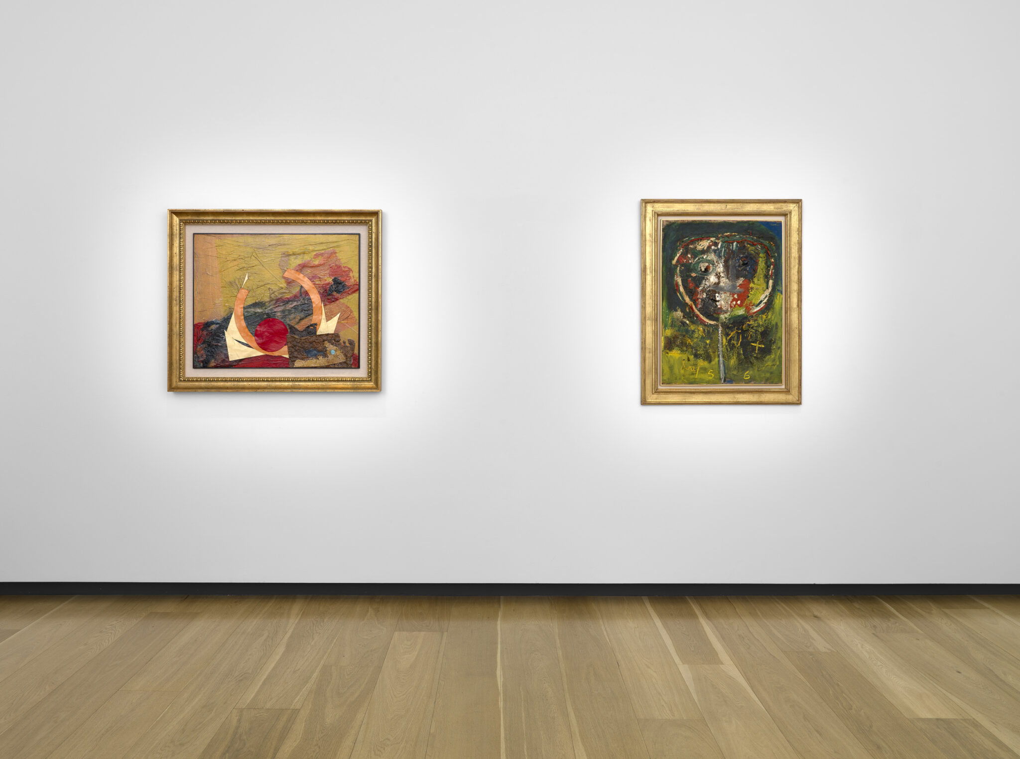 Alt text: A couple of paintings framed and hung on a wall, showcasing modern art in an indoor gallery setting.