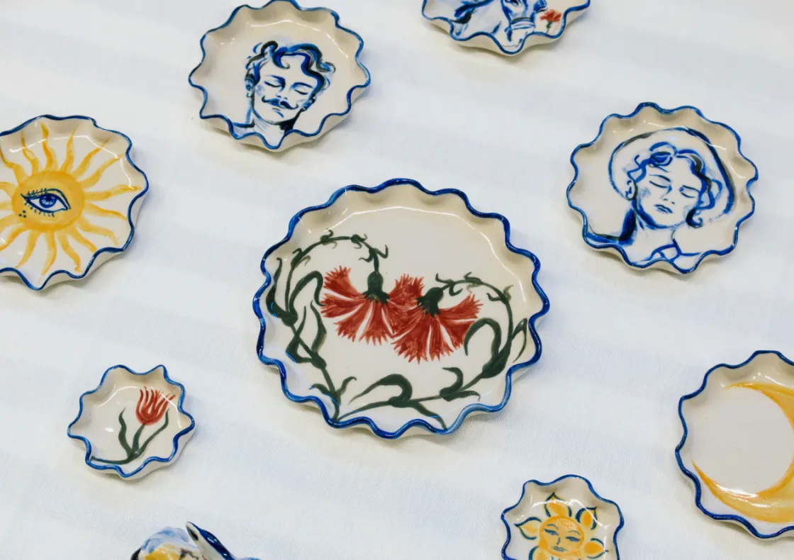 A group of decorative plates featuring intricate designs, showcasing floral patterns in blue and white porcelain. The plates are arranged together, highlighting their artistic ceramic craftsmanship.