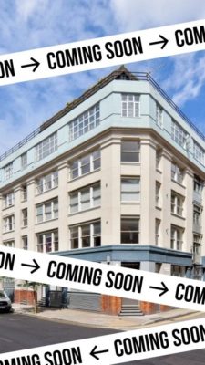 A large white building with a flat roof and multiple windows, overlaid with black "COMING SOON" tape. | 2026 Annka Kultys Gallery
