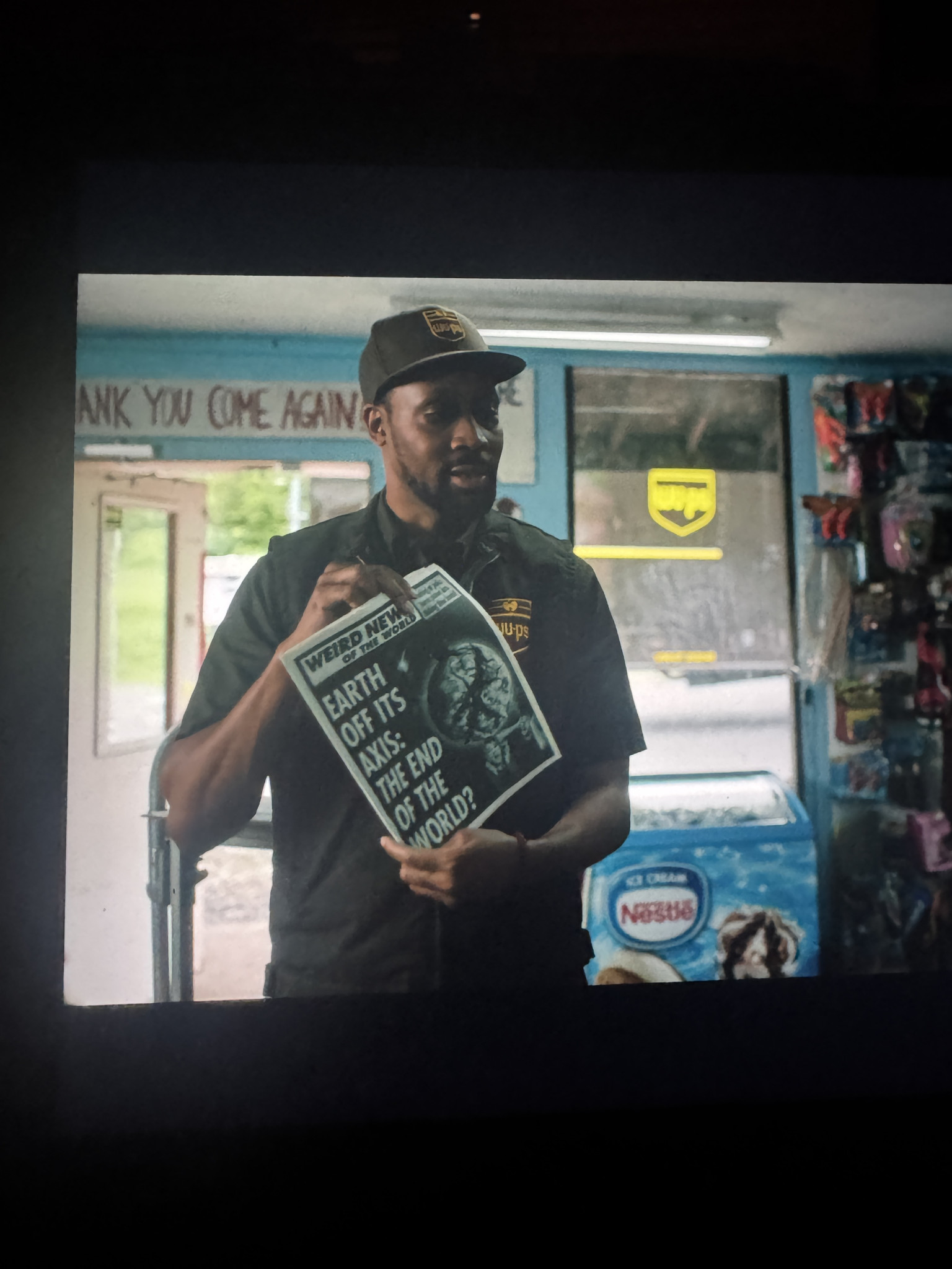 A man holding a newspaper in a store, with a headline about the end of the world.