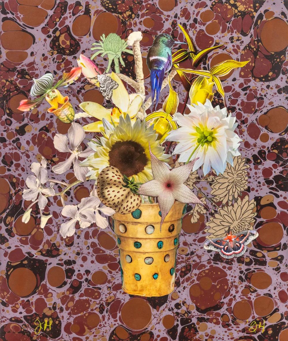 A colorful, artistic arrangement of various flowers and plants in a decorated pot, set against a marbled background.