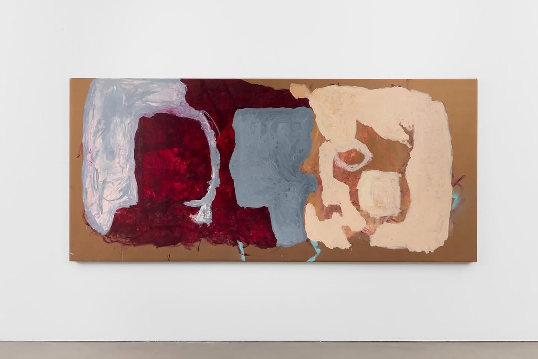 An abstract painting featuring bold colors including red, gray, beige, and white on a canvas mounted on a wall. The composition appears fluid and organic with various shapes and textures.