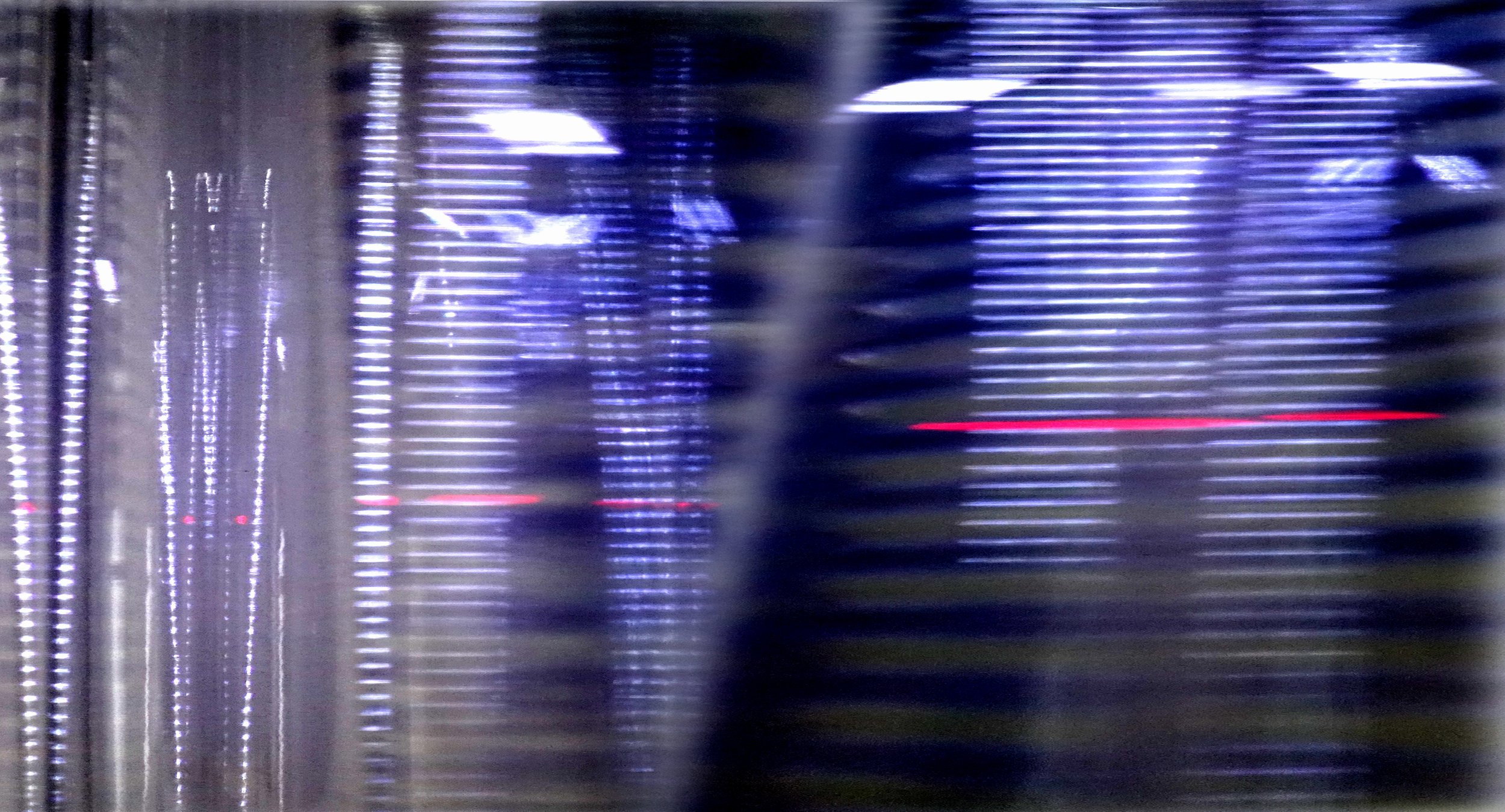 Abstract image with vertical lines of varying colors and brightness, creating a sense of movement and depth.