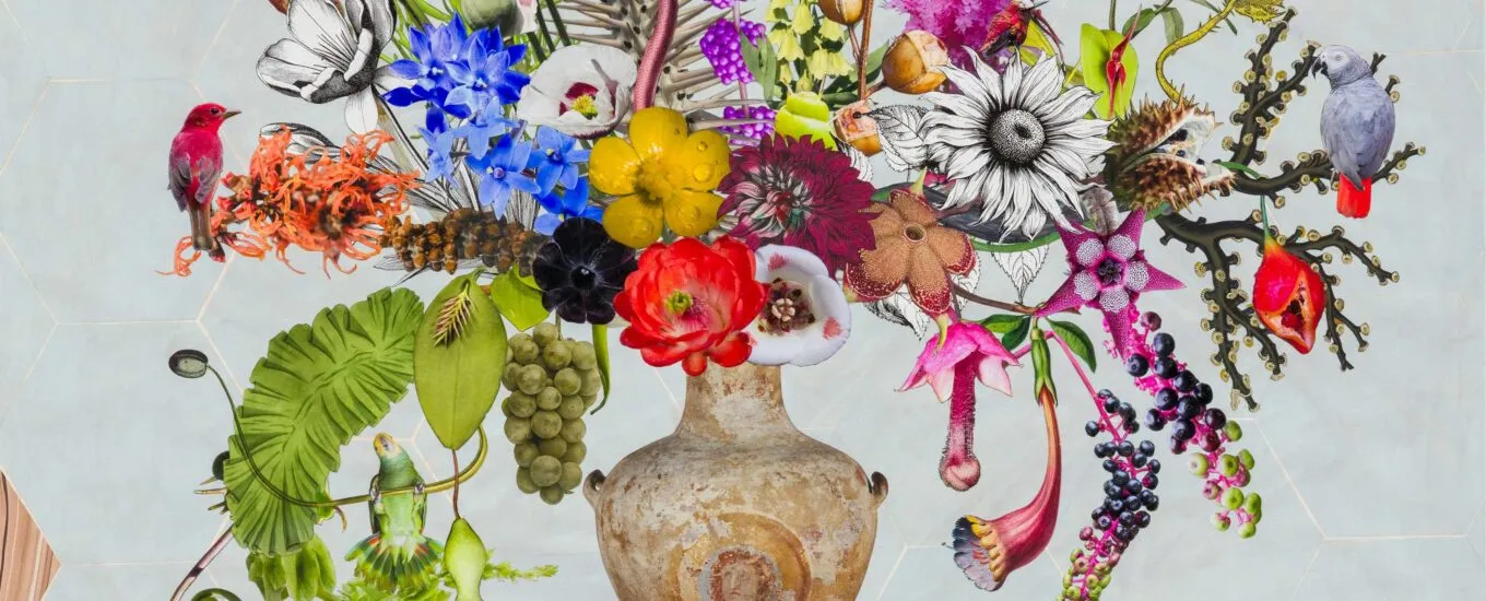 A decorative vase filled with a vibrant arrangement of various flowers, plants, and some animal figures.