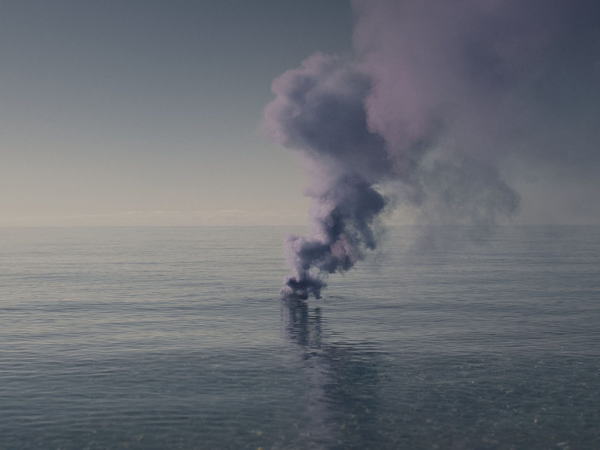 A plume of purple smoke rising from the surface of a calm ocean.