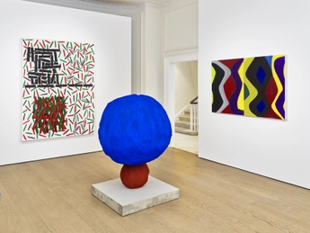 An art gallery featuring three artworks: a large blue spherical sculpture on a pedestal, a colorful abstract painting with various geometric shapes and colors on the left wall, and another vibrant painting with wavy patterns in multiple colors on the right wall.