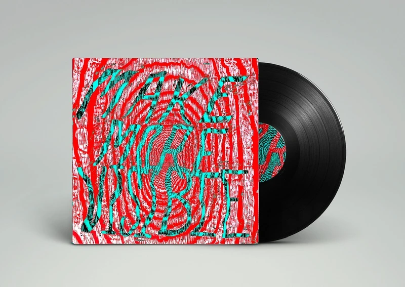 A vinyl record with a colorful album cover that features abstract, vibrant text that reads "MAKE MORE VIBE."