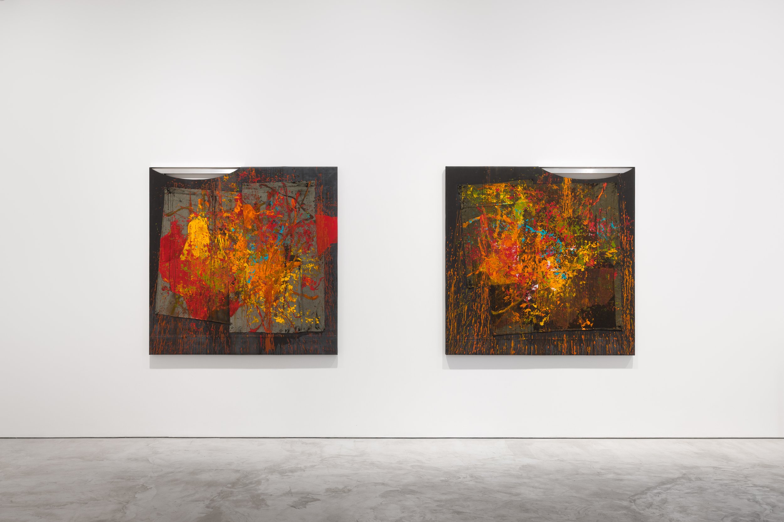 Two abstract paintings displayed on a white wall in an art gallery.