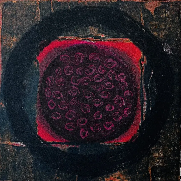 Abstract circular artwork featuring a dark outer ring surrounding a deep red center with circular patterns.