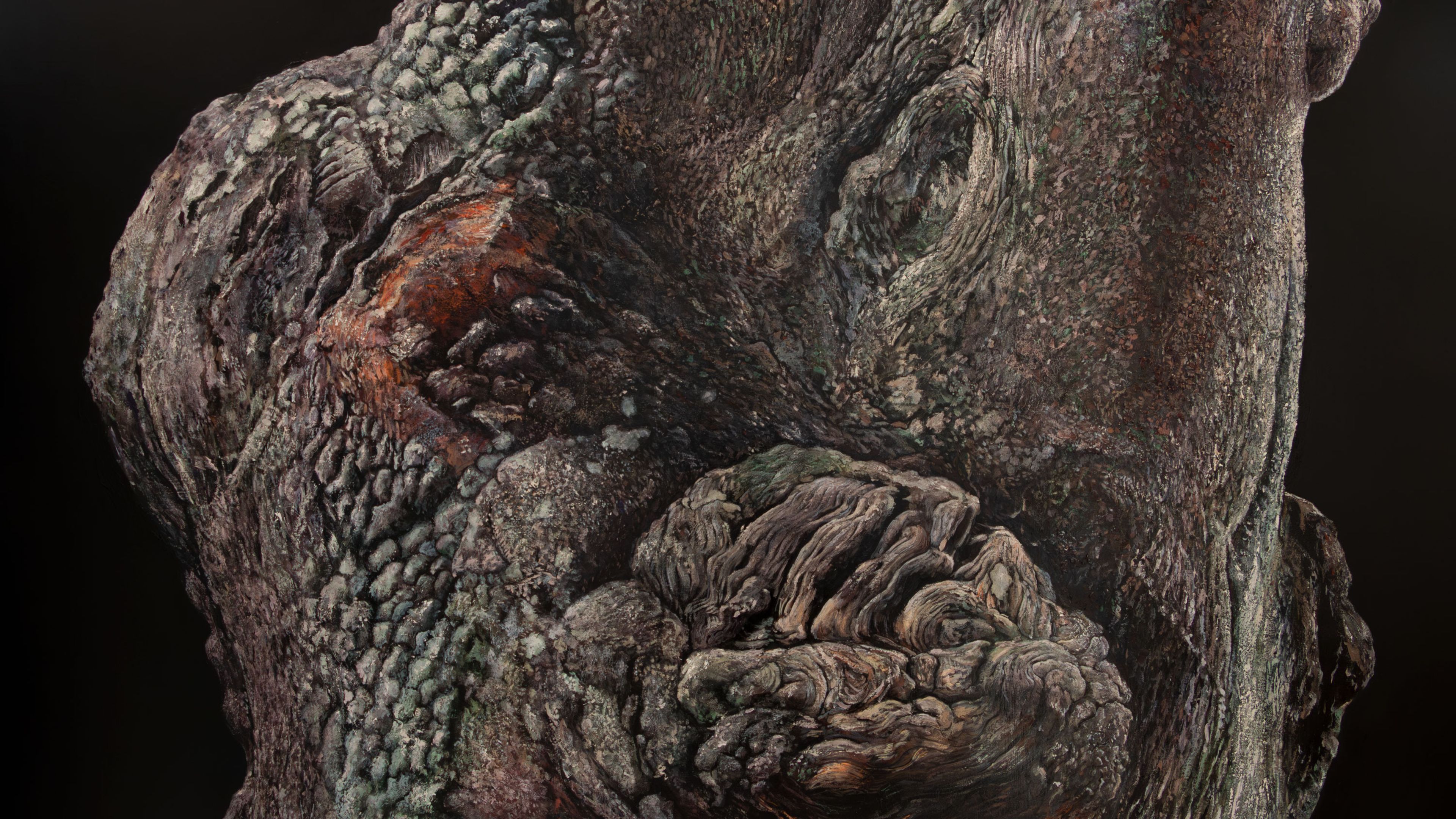 A textured and gnarled tree trunk resembling a humanoid figure with a rounded shoulder and arm.