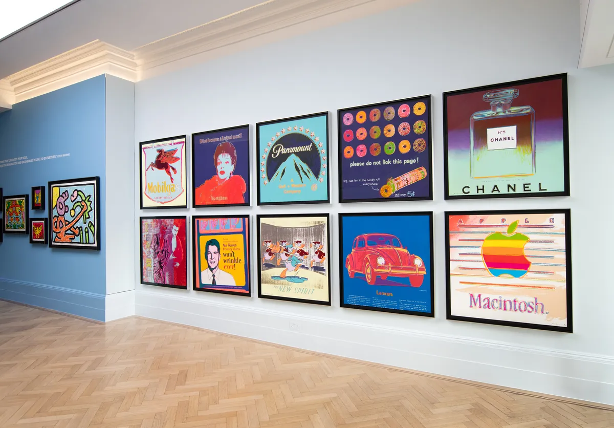 A gallery wall displaying a collection of framed colorful posters and artwork.