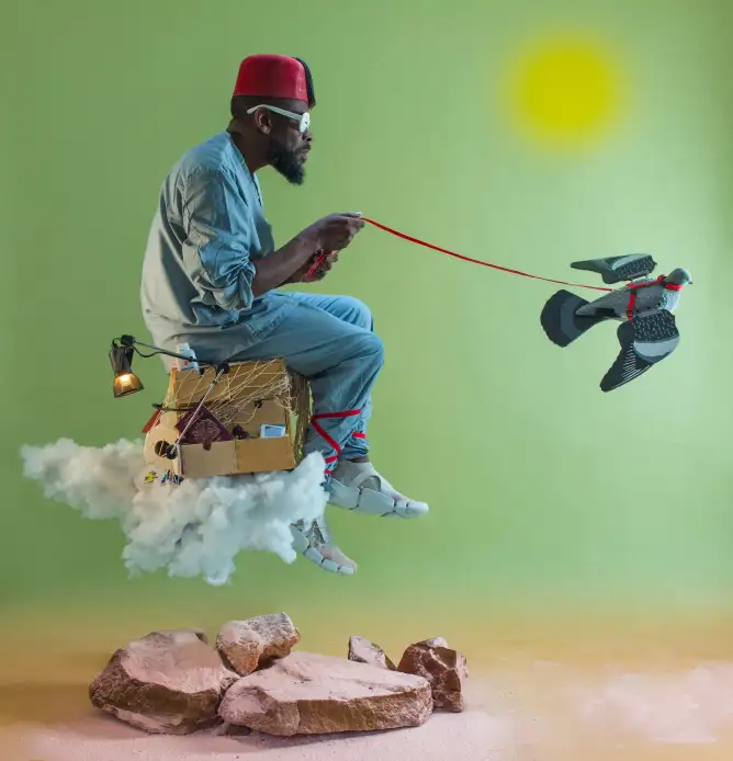 A man wearing a fez sits on a cloud made of cotton, flying with a pigeon on a string, surrounded by rocks and a bright sun.