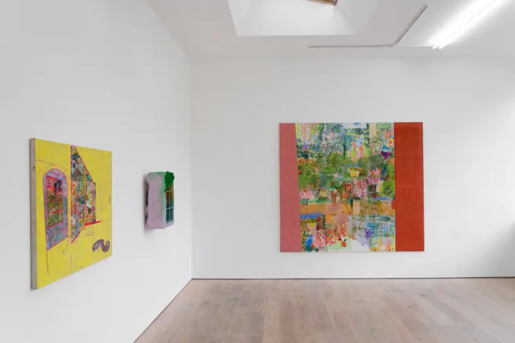Bright, minimalist art gallery with three colorful abstract paintings on white walls, a pale wood floor, and skylights; calm, inviting atmosphere.