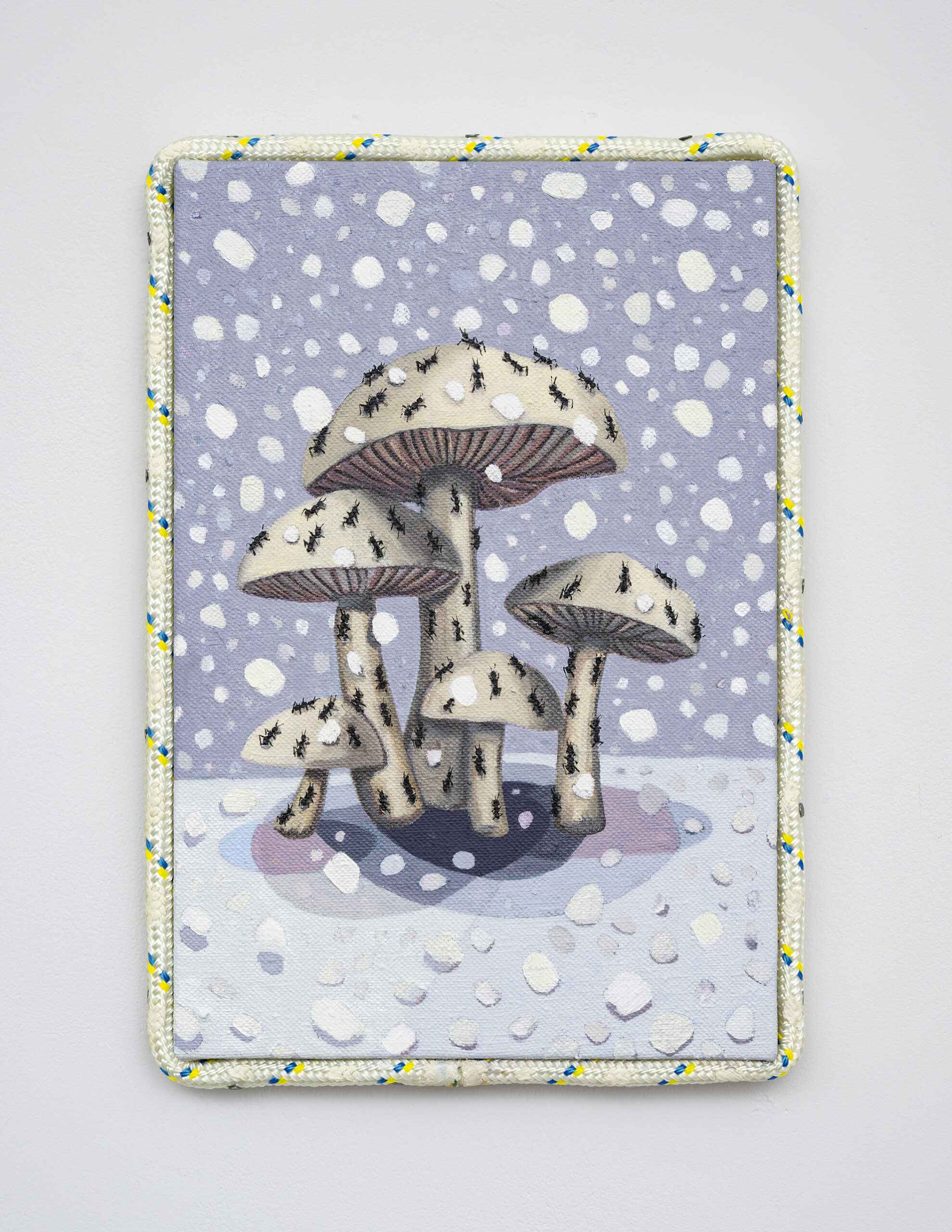 Embroidered mushroom scene on a lavender, snow-speckled fabric panel, framed with a colorful border; whimsical, cozy, woodland tone.